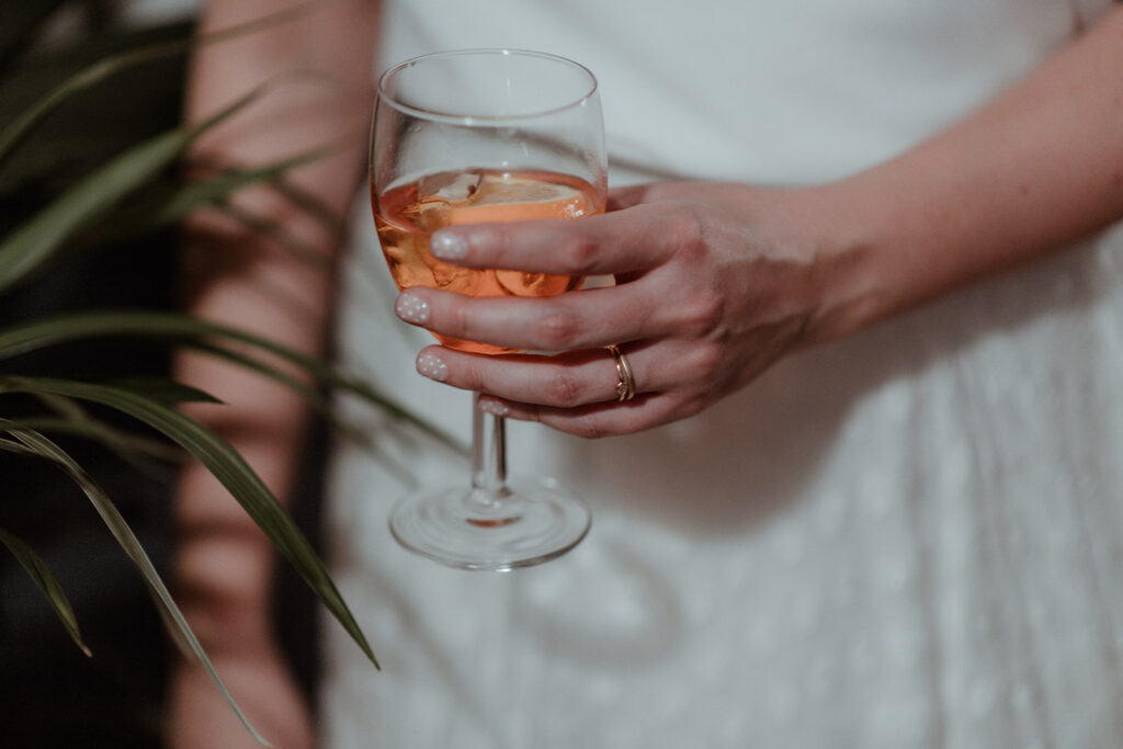 bride holding an aeporol spritz at her wedding reception in london