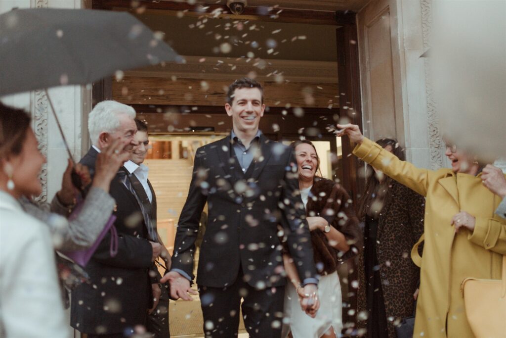 London Islington town hall wedding photography, couple exiting ceremony with confetti