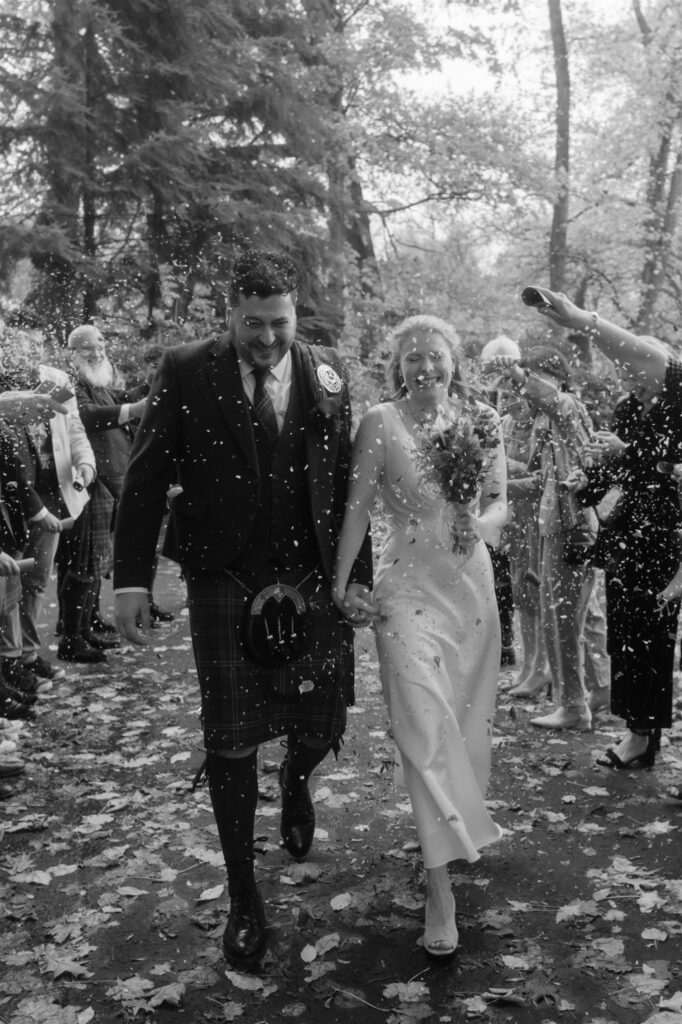 editorial wedding photographer in glasgow, a confetti exit in black and white