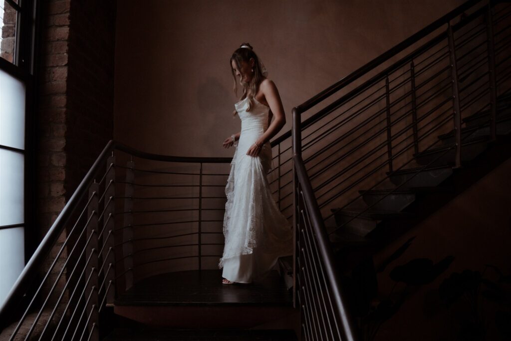 bride walking down staircase on her way to the ceremony at glasgow engine works